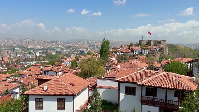 The Turkish flag waves at Ankara Castle, with a view of Ankara city in the background. 4k video.