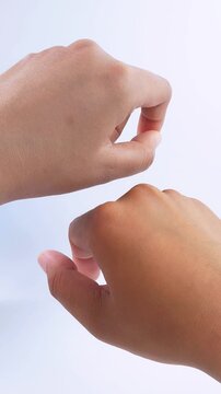 Different skin tones on both hands after using brightening cream. Skincare comparison isolated on white background.