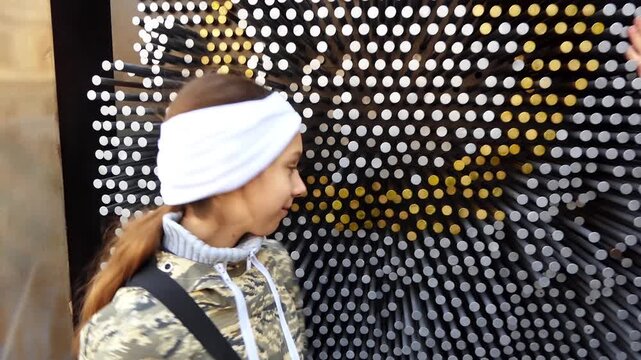 MOSCOW, RUSSIA - JUNE 4 2017: Beautiful teenager girl is playing with metal construction in the street.