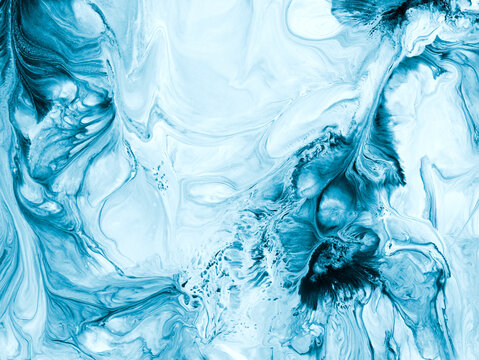 Abstract fluid art background in icy blue and white tones with marble texture and flowing acrylic paint patterns.
