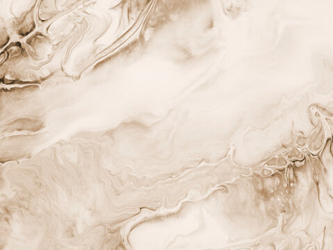 Abstract fluid art background in beige tones with marble texture and flowing acrylic paint patterns. Abstract design with copy space