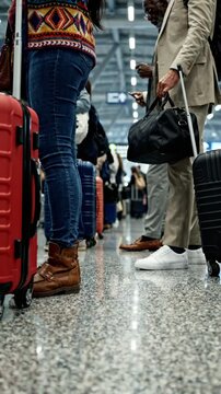 Travelers Queueing at an Airport Check-In Area with Luggage in Tow, Capturing the Busy Atmosphere of Departure and Anticipation Amidst Vibrant Diversity