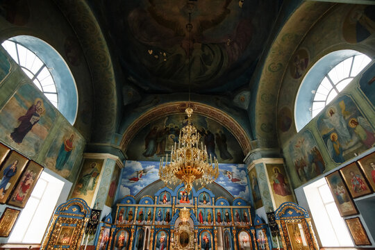 Orthodox church interior with frescoes, iconostasis and vaulted ceiling