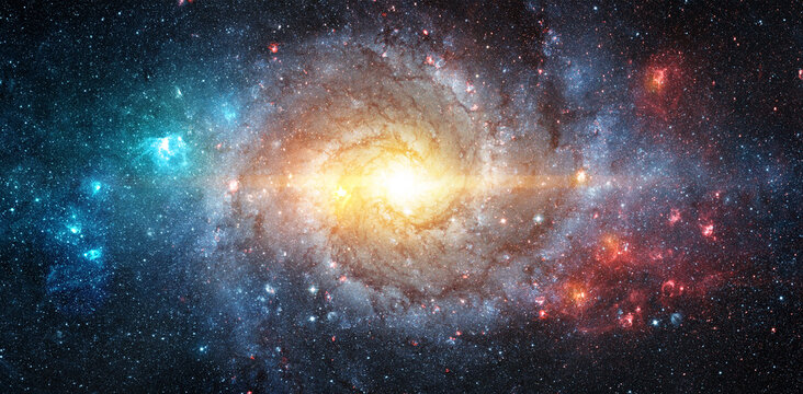 Spiral galaxy in deep space surrounded by stars and cosmic dust. Elements of this image furnished by NASA.
