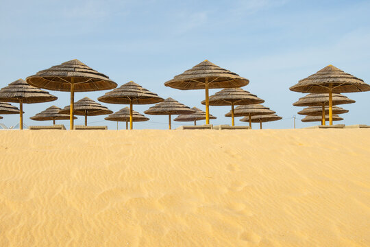 Parasols et sable jaune sur la plage d'Arma&ccedil;&atilde;o de P&ecirc;ra, Algarve, Portugal