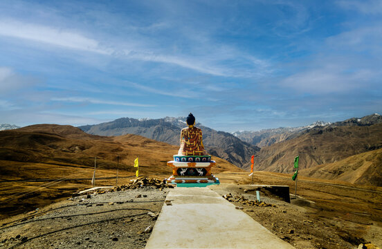 Seated Buddha Monument Overlooking Vast Barren Mountain Terrain under Blue Sky, Langza, India