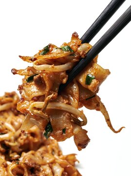 Char Kway Teow Flat Rice Noodles with Bean Sprouts Scallion and Dark Soy on Chopsticks Macro Hawker Food