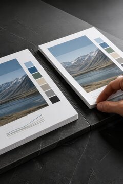 Modern brochure mockup with mountain landscape print and color palette on a dark tabletop