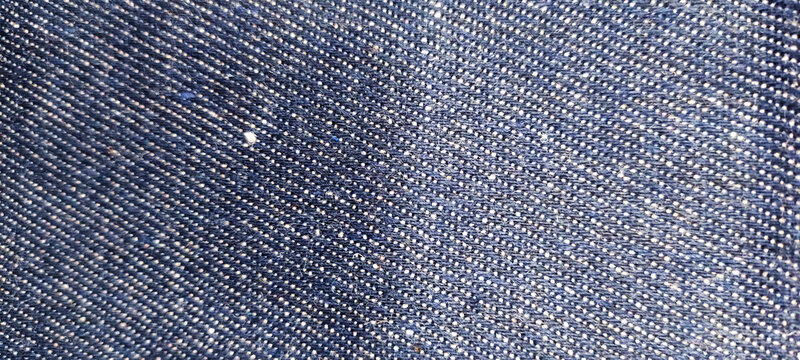 Close-up texture of dark blue denim fabric background
