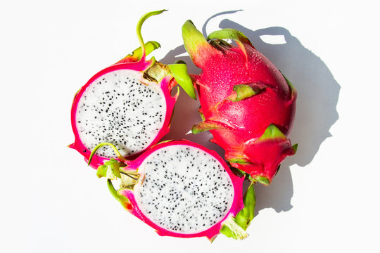 Whole and Cut Dragon Fruit on White Background Top View