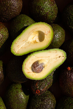 Vertical Natural Half Avocado on Avocado Background