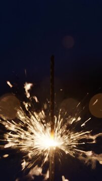 Bright Sparkler Fireworks Exploding with Golden Sparks Against a Dark Night Sky, Celebrating Independence Day