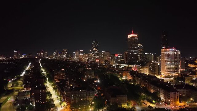 Boston Skyline at Night, Aerial Drone View of Illuminated City Skyscrapers and Downtown Buildings, Financial District Waterfront Harbor Cityscape Evening Lights in Massachusetts, USA