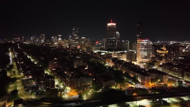 Boston Skyline at Night, Aerial Drone View of Illuminated City Skyscrapers and Downtown Buildings, Financial District Waterfront Harbor Cityscape Evening Lights in Massachusetts, USA
