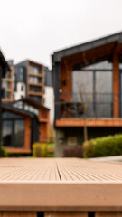 Fototapeta premium Modern wooden deck in foreground with contemporary buildings in background