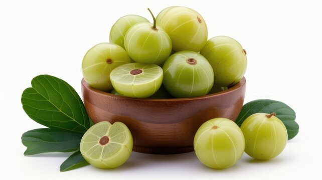 Fresh indian gooseberries or amla fruits in a wooden bowl with green leaves
