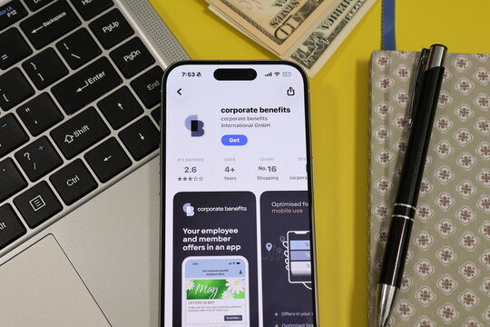 Kiel, Germany - 05-20-2026: Smartphone displaying the corporate benefits employee rewards and discount management app in the App Store in a workspace environment with laptop and notebook