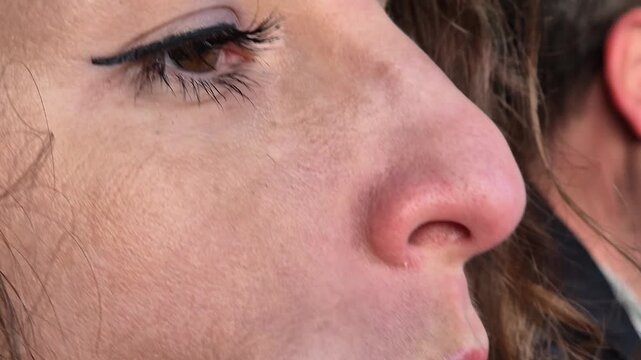 Woman eye eyelashes extreme close up of a female eye with professional makeup during daytime