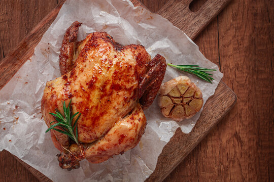 Fried chicken, on parchment paper, on a wooden board, top view, no people,