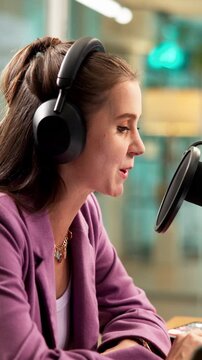 Woman, podcast and headphones in studio with mic, pop culture news and chat for recording broadcast. Happy, person and radio presenter speaking with audio tech, talk show and mainstream media update.