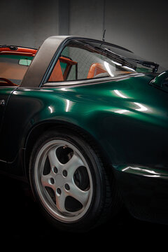 Vintage green sports car showing wheel and targa roof