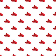 Fototapeta premium Red cinnamon sticks forming a decorative repeating pattern on a white background
