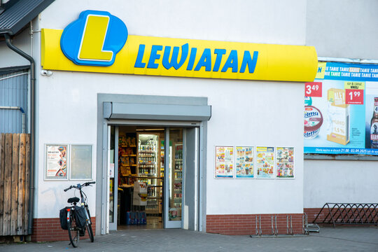 Leba, Poland - August 26, 2025 - Close up of Lewiatan grocery store entrance with promotional posters and a bicycle