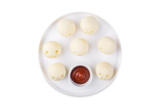 Potato gnocchi in the form of monsters with tomato sauce on a white isolated background