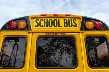Back view of a classic yellow school bus with emergency door and lights © Don Mroczkowski