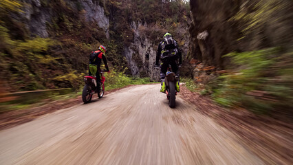 Motorcycle racers riding extreme offroad trail in forest © Chris M