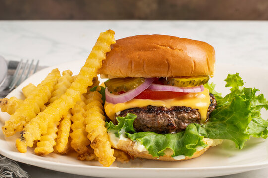 cheese burge  with a side of french fries