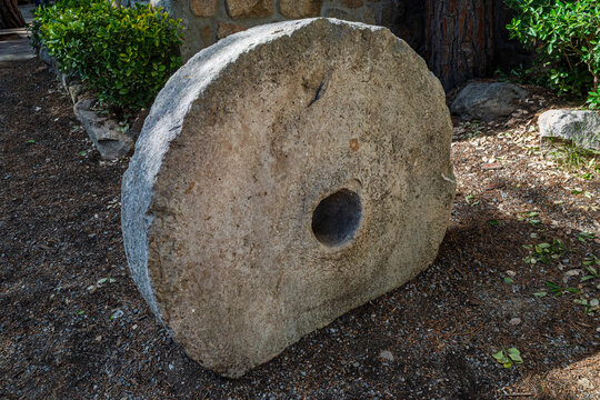 Historic Grinding Stone Millstone in Outdoor Garden
