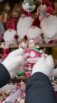 Close Up Hands Choosing Christmas Decoration at Holiday Market Stall