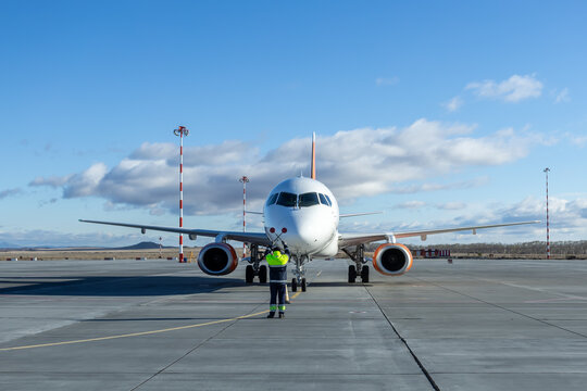 Airplane marshalling at the aiport. Passenger aircraft meeting