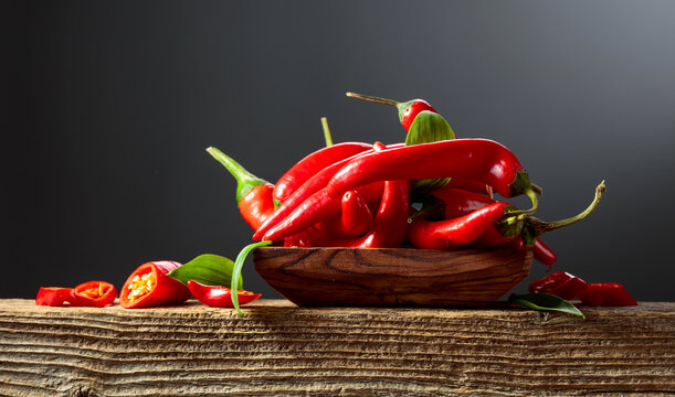 Red hot chili peppers on an old wooden table.