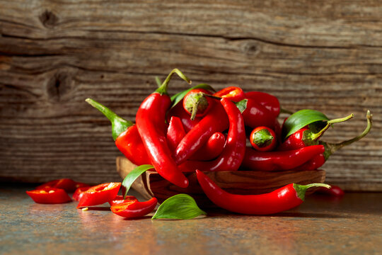 Red hot chili peppers on a old wooden background.