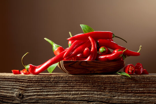 Red hot chili peppers on an old wooden table.