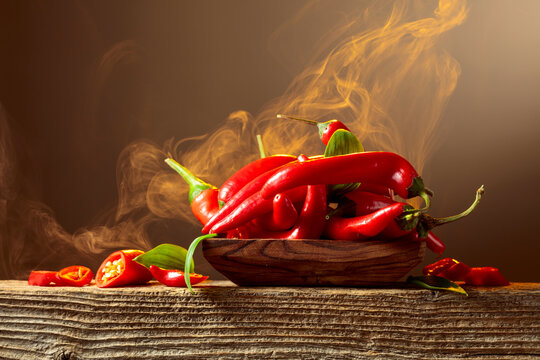 Red hot chili peppers on an old wooden table.