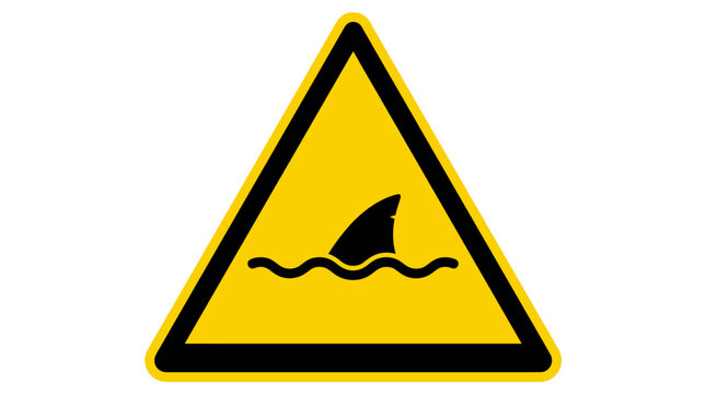 A yellow triangular warning sign depicting a shark fin emerging from wavy water.