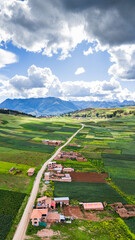 Naklejka premium Vertical aerial view of the cultivated fields near the Huaypo lagoon in the Sacred Valley of the Incas in Cusco, Peru