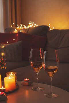 Cozy evening scene with candles, wine glasses