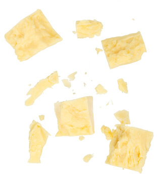 Crumbled parmesan cheese chunks and crumbs isolated background. Top view flat lay food texture for packaging and design.