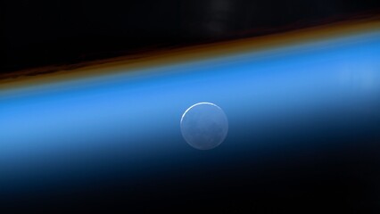 blue ozone layer of planet earth. distant silhouette of the full moon. satellite point of view. NASA Public Domain Imagery © Marcin Janiec