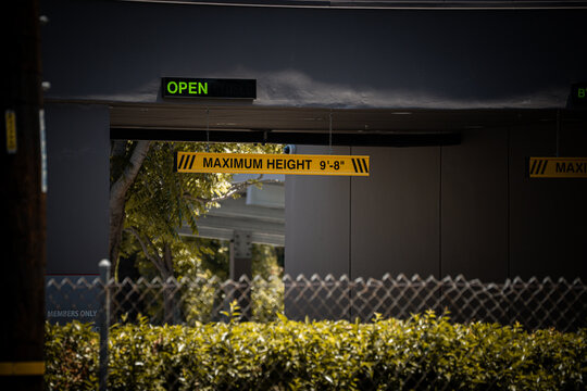 Maximum height sign indicates clearance for vehicles entering a facility