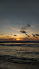 Obraz premium sunset over the sea orange sunset dark sky