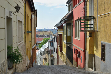 Fototapeta premium Charming cobblestone Gül Baba street with its colorful facades in Budapest, Hungary.
