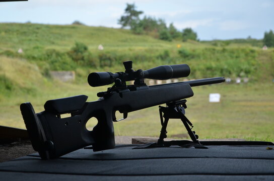 Tactical sniper rifle with optical scope on bipod at outdoor shooting range