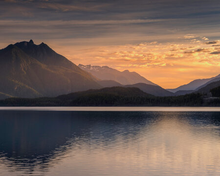 Scenic sunset golden hour over a calm mountain lake wilderness