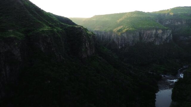 Majestic Santiago River and Mountain Canyon at Sunset Featuring a Cinematic Aerial Drone Push In View of Lush Green Forests in Guadalajara Mexico