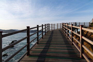 Fototapeta premium Wooden Coastal Boardwalk Overlooking Blue Ocean Horizon